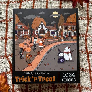 Experience a wave of nostalgia with the Trick R’ Treat | 1,024 Piece Jigsaw Puzzle from Little Spooky Studio, featuring a charming Halloween-inspired scene of costumed children trick-or-treating at dusk in a suburban neighborhood—perfect for fans of the Little Spooky Studio puzzle series or anyone seeking the ultimate ghostly puzzle adventure.
