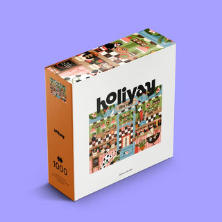 Experience the charm of Holiyay Puzzles with the “Chocolate House” 1,000-piece jigsaw puzzle, featuring a vibrant kitchen scene inspired by Didilanoli’s whimsical style, beautifully presented against a purple background—ideal for anyone who delights in chocolate shop puzzles.