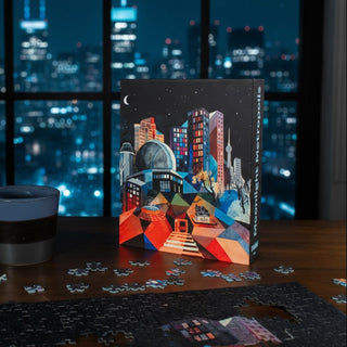 The Moonlight Metropolis 650-piece jigsaw puzzle by Chuffed Puzzles, featuring a vibrant cityscape, sits partially completed on a table beside a cup, while the nighttime city skyline shimmers through the window.