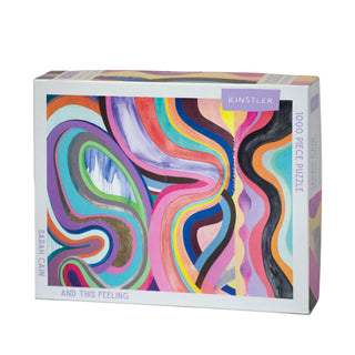 The “And This Feeling” 1,000 piece jigsaw puzzle by Kinstler Puzzles features abstract, colorful wavy art by Sarah Cain and celebrates bold feminist artists.
