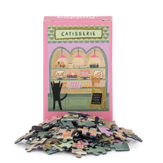 The Catisserie | 99 Piece Mini Jigsaw Puzzle by Happily Jigsaw Puzzles features a charming cat bakery scene—ideal for cat lovers and puzzle fans alike.
