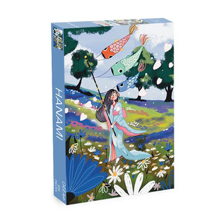 A vibrant box from Olleo Puzzles labeled "Hanami | 500 Piece Jigsaw Puzzle" shows an illustrated woman in traditional attire with koi streamers, flowers, and trees under a blue sky—ideal for cherry blossom or sakura puzzle fans.