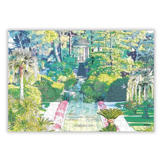 Aparté's "The Temple of Love | 500 Piece Jigsaw Puzzle" features a lush garden scene with palm trees, a pathway, and a domed gazebo, shown as an illustration of the partially completed puzzle.