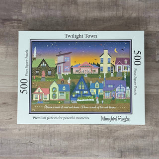 The Mimsybird Puzzles Twilight Town | 500 Piece Jigsaw Puzzle features vibrant houses beneath an evening sky. The box reads: “Premium puzzles for peaceful moments.”.