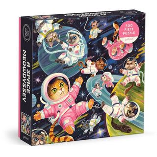 A Space Meowdyssey is a 500-piece jigsaw puzzle by Galison, featuring illustrated cats in space suits floating among planets and stars.