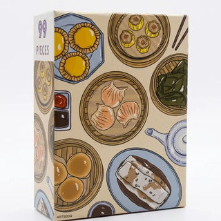 The Dim Sum | 99 Piece Jigsaw Puzzle by Arcadia Puzzles features illustrated dim sum dishes and a matte finish, with "99 Pieces" labeled on the top left corner of the box.