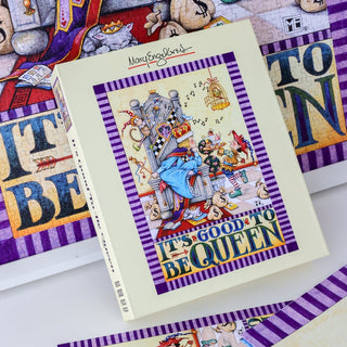 The WEVE "It's Good To Be Queen" 1,000 Piece Jigsaw Puzzle features Mary Engelbreit’s delightful artwork of a queen on her throne, surrounded by cats and the uplifting phrase “IT’S GOOD TO BE QUEEN.” Made from premium blue board, the assembled puzzle can be partially seen in the background.