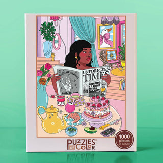 Unforeseen Times | 1,000 Piece Jigsaw Puzzle box featuring an illustration by Mimi Moffie of a woman reading a newspaper at a table set with a tea service, a cake, and various trinkets.