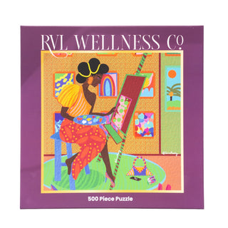 The Painter | 500 Piece Jigsaw Puzzle by RVL Wellness Co. features a woman at a table and is perfect for art lovers or anyone seeking a relaxing self-care activity.