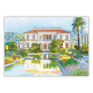La Villa Ephrussi De Rothschild | 1,000 Piece Jigsaw Puzzle by Aparté features a red-tiled villa, lush gardens, palm trees, and a reflective pond—ideal for puzzle enthusiasts.