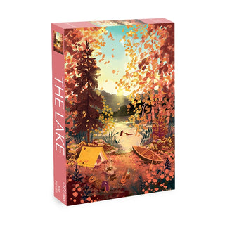Experience tranquility with Olleo Puzzles’ The Lake | 500 Piece Jigsaw Puzzle. This beautifully illustrated box depicts an autumn lakeside retreat complete with a tent, rowboat, campfire, and vibrant trees. Perfect for relaxation, the puzzle is packaged in a box featuring “THE LAKE” vertically along the side and showcases an enchanting nature scene that brings the peaceful outdoors to life.