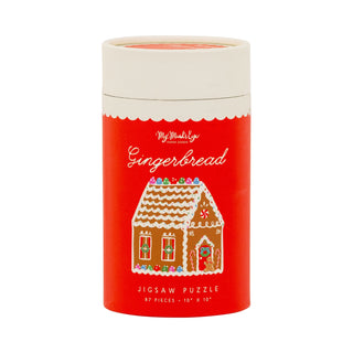 A red cylindrical container labeled “Gingerbread | 87 Piece Jigsaw Puzzle” by My Mind’s Eye, featuring an illustration of a gingerbread house on the front. This delightful kids’ puzzle includes 87 sturdy chipboard pieces and measures 10 x 10 inches.
