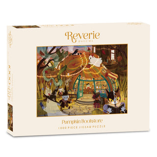 Box of a 1,000-piece Pumpkin Bookstore jigsaw puzzle by Reverie Puzzles, featuring an illustrated scene of animals gathered around a whimsical pumpkin-shaped bookstore—the perfect Halloween puzzle for cozy autumn nights.