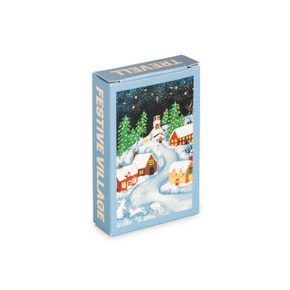 A blue box labeled Trevell Festive Village | 99 Piece Jigsaw Puzzle features an illustrated snowy village scene with houses, trees, and a church on the front. Made in Turkey, this charming puzzle is perfect for celebrating the season.