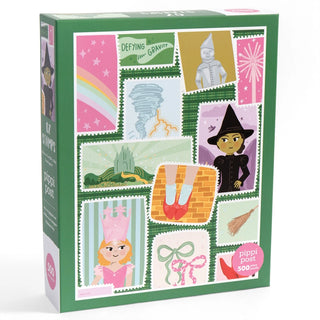 The "Postage Stamps from Oz" 500-piece jigsaw puzzle by Pippi Post features colorful illustrations inspired by The Wizard of Oz, showcasing characters, a tornado, a rainbow, and iconic items such as ruby slippers and a broomstick.