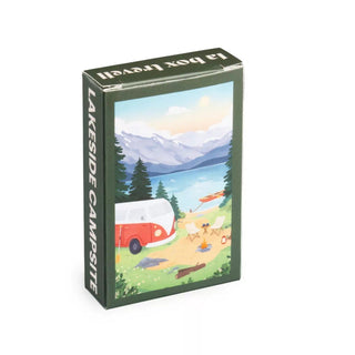 The Trevell Lakeside Campsite | 99 Piece Jigsaw Puzzle features a charming scene with a red van, lake, trees, mountains, and canoe—an eco-friendly puzzle perfect for relaxing moments.