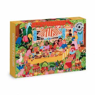 The Goûter Fleuri 1,000 Piece Jigsaw Puzzle by Trevell features a colorful illustration inspired by Anaïs Sanchez, showing a joyful outdoor tea party with diverse guests, floral décor, food, and drinks.