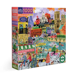 The eeBoo "Paris in Autumn" 1,000 Piece Jigsaw Puzzle showcases a vibrant illustrated Paris scene with landmarks like the Eiffel Tower and Notre-Dame, outdoor cafes, and a cozy autumn vibe.