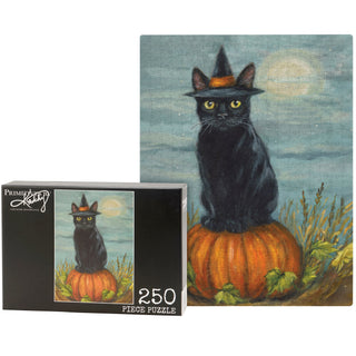 The Primitives by Kathy "Black Cat Witch" 250-piece jigsaw puzzle features a black cat in a witch hat on a pumpkin before a full moon, with the same magical design showcased on the box.