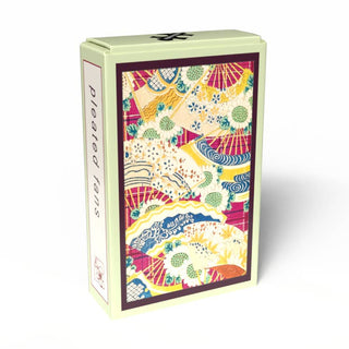 A rectangular box from Penny Puzzle, decorated with a vibrant pattern of pleated fans and flowers, reminiscent of vintage Japanese puzzles, and labeled "Pleated Fans | 99 Piece Jigsaw Puzzle" on the side.
