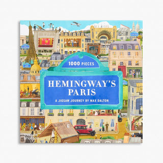 The Hemingway’s Paris | 1,000 Piece Jigsaw Puzzle box displays a colorful, detailed illustration of landmarks and city life.