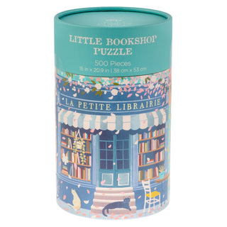 Presented in a cylindrical box, the Karma Little Bookshop | 500 Piece Jigsaw Puzzle features whimsical artwork of a storefront filled with books, plants, and cats. Adorned with the phrase “La Petite Librairie,” this charming puzzle makes a delightful gift for book lovers and anyone who enjoys 500-piece puzzles, capturing the cozy ambiance of a neighborhood bookstore.