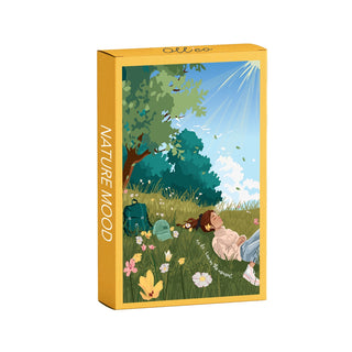 Olleo Puzzles’ Nature Mood 99 Piece Jigsaw Puzzle features art by Mathilde Garcia of two people relaxing under a tree with flowers, backpacks, and sunlight—a charming scene perfect for peaceful daydreams.