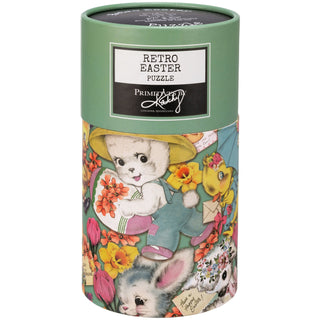 The Retro Easter | 1,000 Piece Jigsaw Puzzle by Primitives by Kathy comes in a cylindrical box decorated with vintage-style bunnies and chicks holding flowers and Easter eggs.