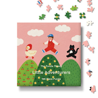Introducing Little Adventurers | 196 Piece Jigsaw Puzzle by The Puzzle Theory—a whimsical children’s puzzle featuring a charming illustration of a child, a cat, and a duck strolling across rolling green hills, with loose pieces inviting playful assembly. Crafted from recycled paperboard, this delightful puzzle blends eco-friendly fun with imaginative play.