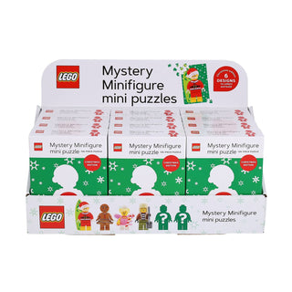 Display box of Chronicle Books’ LEGO Mystery Minifigure (Christmas Edition Green) 126-piece jigsaw puzzles, featuring multiple boxed puzzles and images of possible minifigure mini puzzle designs on the front—a perfect holiday surprise for LEGO fans.