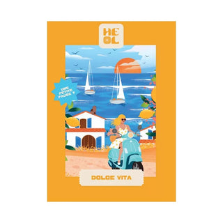 Illustration of a sunny coast with sailboats, white houses, lemon trees, and a scooter rider with a dog; text: DOLCE VITA. Enjoy the 99-piece Dolce Vita Jigsaw Puzzle by Heol Editions—made in France.