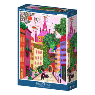 The Mexico | 500 Piece Jigsaw Puzzle by Pieces & Peace features colorful, whimsical buildings and trees with people walking and biking in a lively city scene. Illustrated by Eva Jael and made in France.