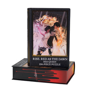 A rectangular Rise, Red As the Dawn | 250 Piece Jigsaw Puzzle box featuring an illustration of a woman surrounded by lightning and a man surrounded by fire.