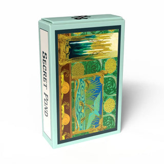 A mint green box labeled “Secret Pond | 99 Piece Jigsaw Puzzle” by Penny Puzzle showcases intricate gold, green, and blue artwork with cranes and abstract nature patterns on the front, evoking the timeless elegance of Maurice Pillard Verneuil and reminiscent of a vintage Art Nouveau vase.