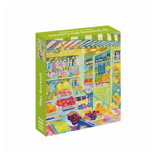 A 1,000 piece WEVE Grocery Day jigsaw puzzle box with a soft-touch finish, featuring a colorful illustration of an open-air grocery store with a dog sitting in the entrance.