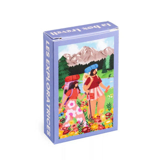 The Trevell Les Explora Trices 99-piece jigsaw puzzle features two women hiking with mountains in the background and LES EXPLORATRICES on the side. This small puzzle also supports 1% for the Planet.