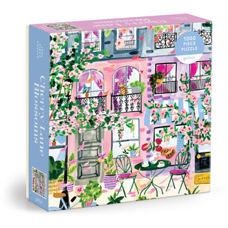 Galison’s Cherry Lane Blossoms is a 1,000-piece puzzle with Sabina Fenn’s art of a pink building, balconies, green plants, and a tea table set amid blossoms.