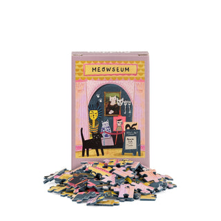 The Meowseum | 99 Piece Mini Jigsaw Puzzle by Happily Jigsaw Puzzles features illustrated cats in an art gallery, with loose mini jigsaw pieces surrounding the box.
