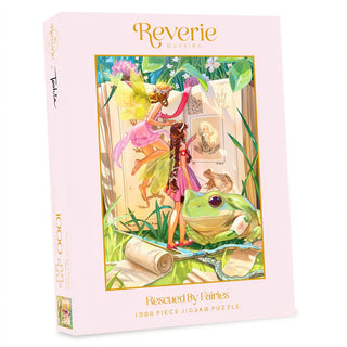 Rescued By Fairies 1,000-piece jigsaw puzzle featuring fairy artwork of two fairies observing a large frog and an open book of botanical drawings.