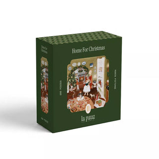 The Home For Christmas | 280 Piece Jigsaw Puzzle by la pauz features a green box with an illustrated festive family scene, complete with a tree and gifts. This charming holiday puzzle contains 280 pieces.