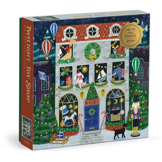 Enjoy a delightful puzzle experience with the Twilight Toy Shop | 500 Piece Jigsaw Puzzle from Galison, featuring a charmingly illustrated holiday toy shop adorned with wreaths, toys displayed in the windows, hot air balloons, a playful black cat, and festive decorations—perfect for anyone who loves whimsical puzzles.