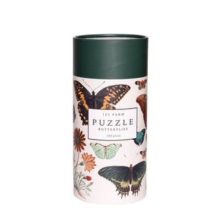 A cylindrical container from 123 Farm, decorated with butterfly and flower designs, contains the Butterflies | 500 Piece Jigsaw Puzzle inside.