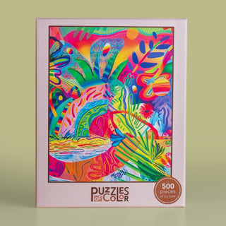 A Pachanga Familiar 500 Piece Jigsaw Puzzle box featuring a colorful, abstract tropical illustration inspired by Mexican art, with bright patterns and foliage.