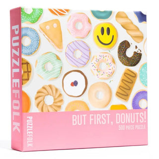 The But First, Donuts | 500 Piece Jigsaw Puzzle by Puzzlefolk features playful illustrations of various donuts and pastries on the box front.