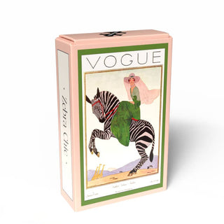 Zebra Chic | 99 Piece Jigsaw Puzzle by Penny Puzzle comes in a pink rectangular box with vintage Vogue art of a woman in green riding a zebra and “Zebra Chic” on the side, celebrating classic fashion magazine covers.