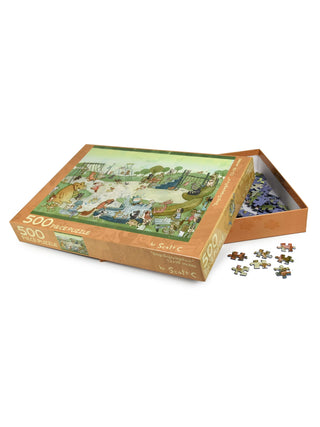 A partially open box of the Scott C Shop "Dogs Enjoying Park | 500 Piece Jigsaw Puzzle" displays loose and scattered pieces, teasing the playful park scene with dogs featured in this delightful children’s puzzle.