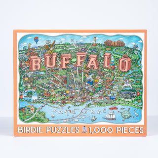 Birdie Puzzles’ Buffalo | 1,000 Piece Jigsaw Puzzle features an illustrated Buffalo map with landmarks and “BUFFALO” in bold letters over Lake Erie—an ideal gift for Buffalo, NY fans.