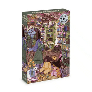 Discover the “Potion Kitchen | 500 Piece Jigsaw Puzzle” by Trevell—a delightful puzzle box featuring an illustrated, whimsical kitchen scene filled with two people, vibrant plants, shelves lined with books, and enchanting magical items.