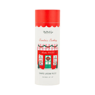 A tall cylindrical box with a red lid, labeled “Santa’s Bakery” by My Mind’s Eye, showcases an illustration of a festive bakery on the front and contains a sturdy chipboard jigsaw puzzle titled “Santa’s Bakery | 500 Piece Jigsaw Puzzle,” featuring 503 uniquely shaped pieces.