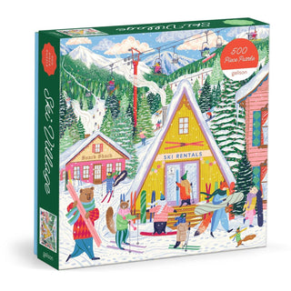Galison’s Ski Village | 500 Piece Jigsaw Puzzle features an illustrated scene of vibrant ski village buildings, people skiing among snowy mountains, and delightful woodland animals hidden throughout the winter landscape.